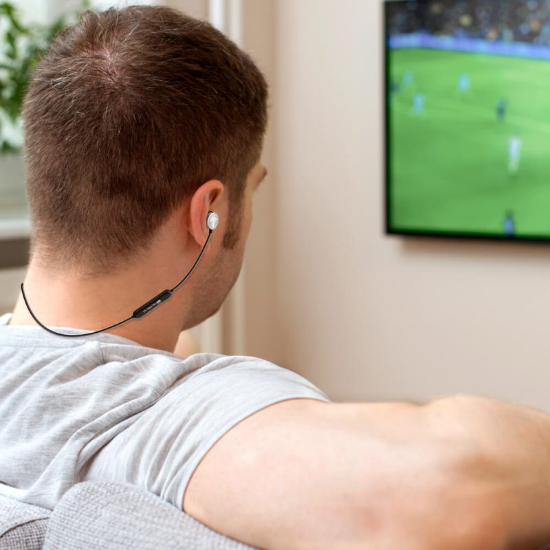 man on couch wearing headphones